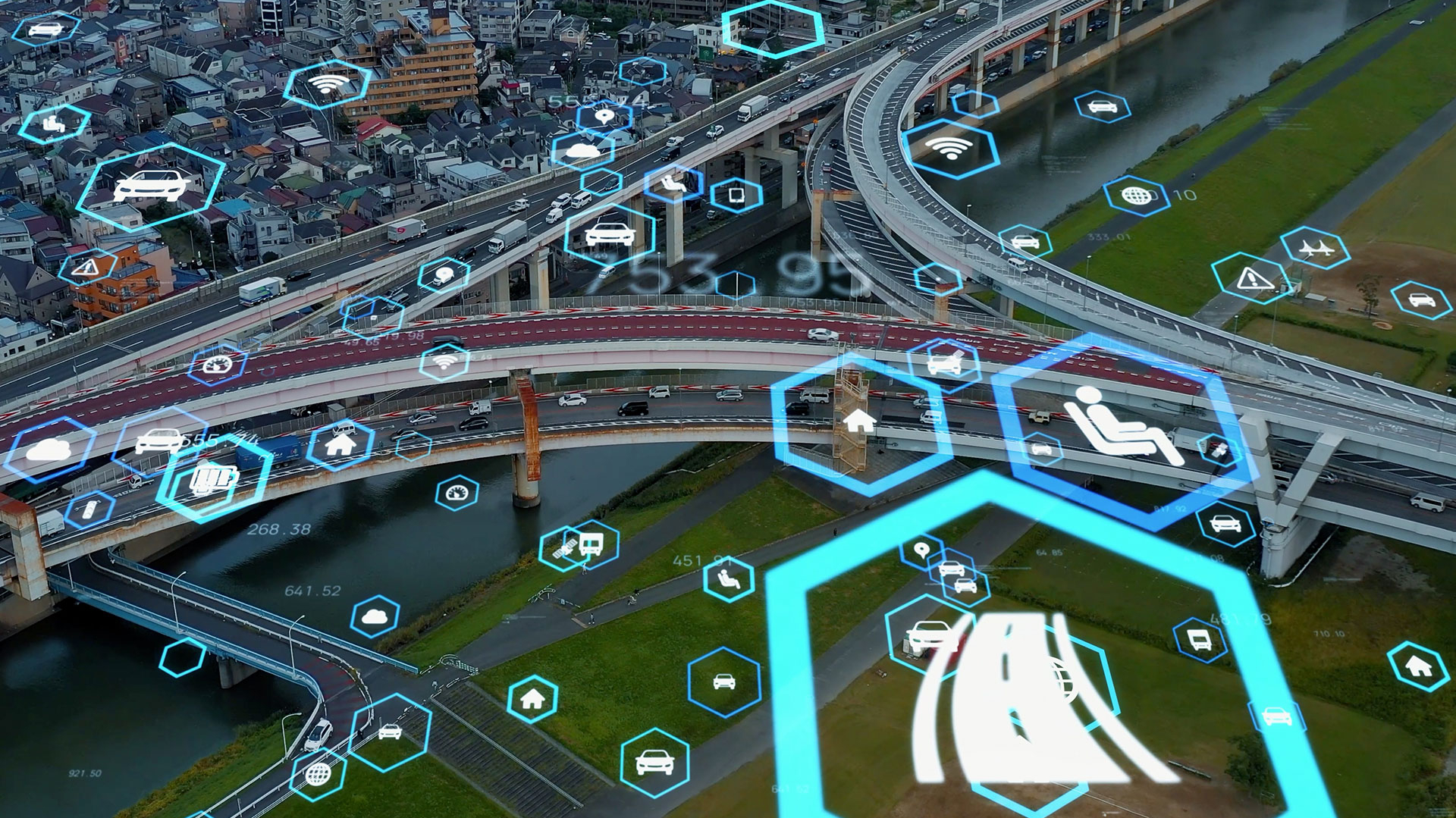 Aerial view of a highway and river illustrating Kapsch's traffic intelligence solutions for proactive traffic management.