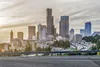 A highway with a city skyline in the background, showcasing Kapsch TrafficCom's advanced traffic management solutions.