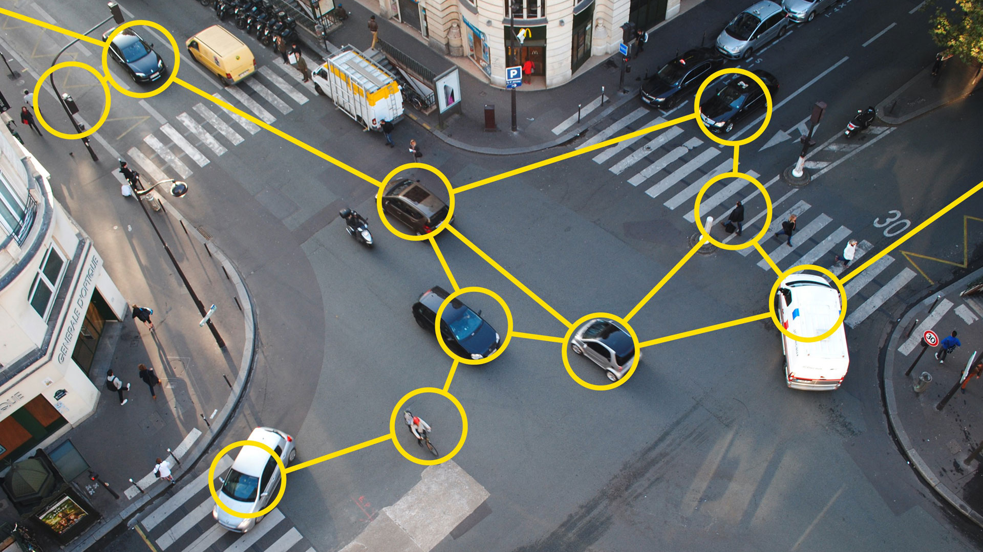 Aerial view of a street with cars and pedestrians, illustrating Kapsch's Orchestrated Connected Corridors for advanced traffic management.