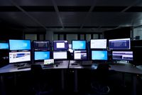 A number of screens in the control room