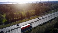 Truck with red trailer on highway, DK