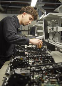 A worker manually inspecting a set of products