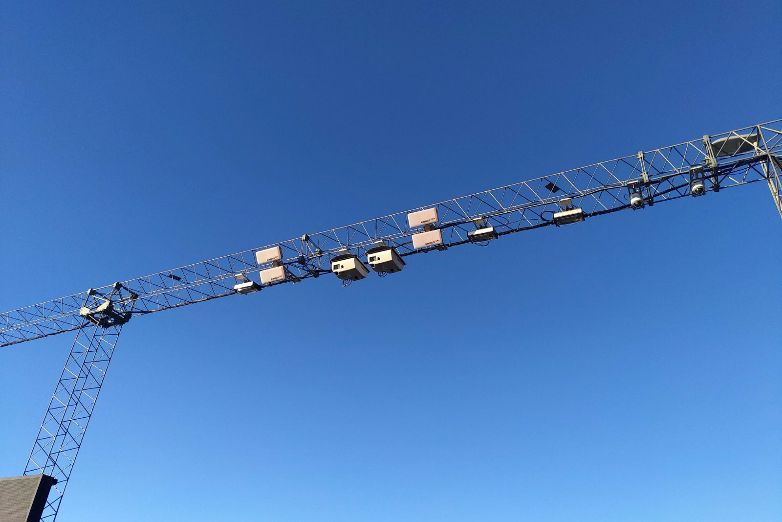 A large metal structure with lights and wires used for Kapsch TrafficCom's All Electronic Tolling system.