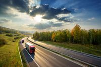 Three red trucks on Highway