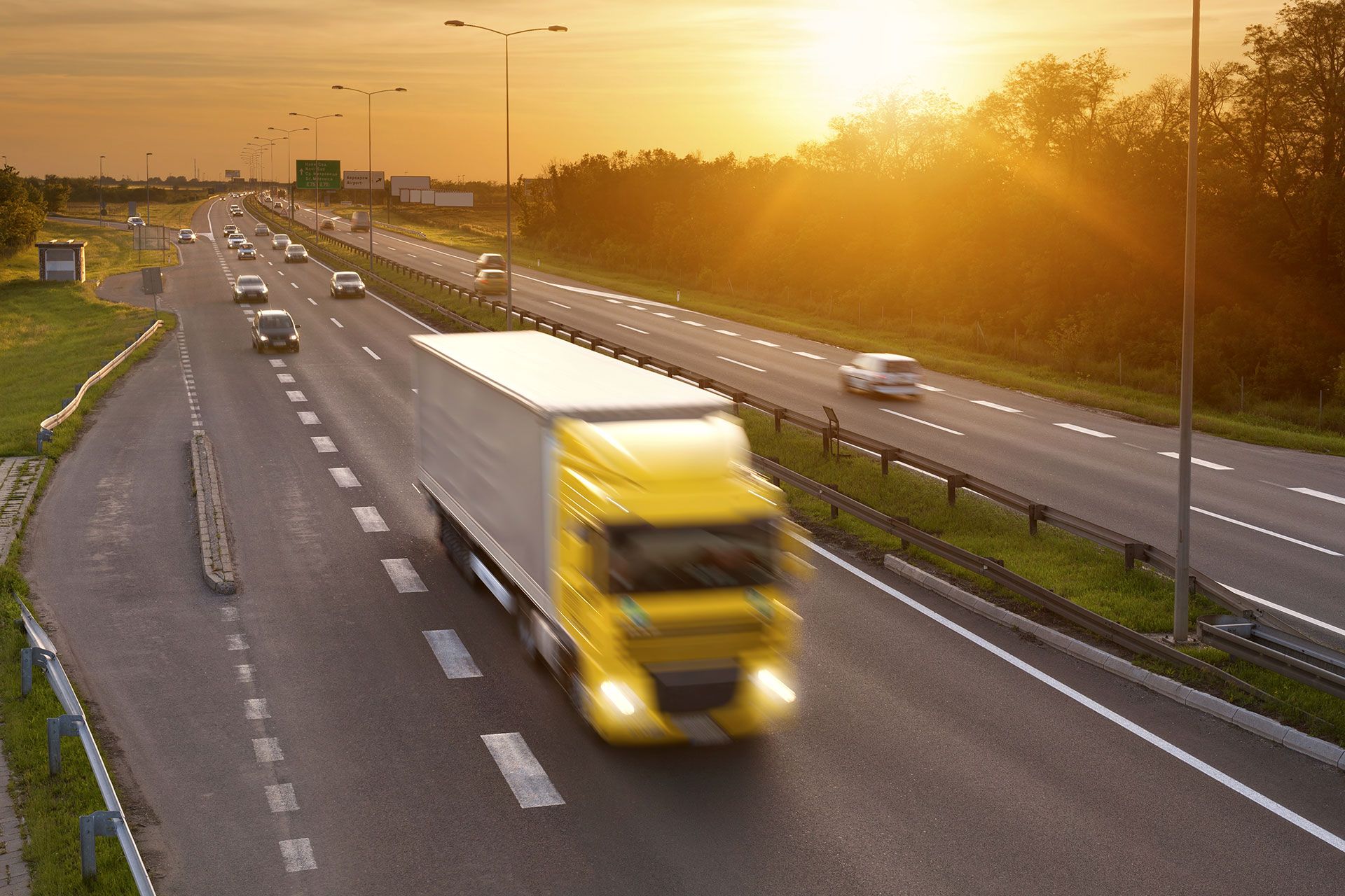 Commercial truck traveling on a highway equipped with connected vehicle technology.