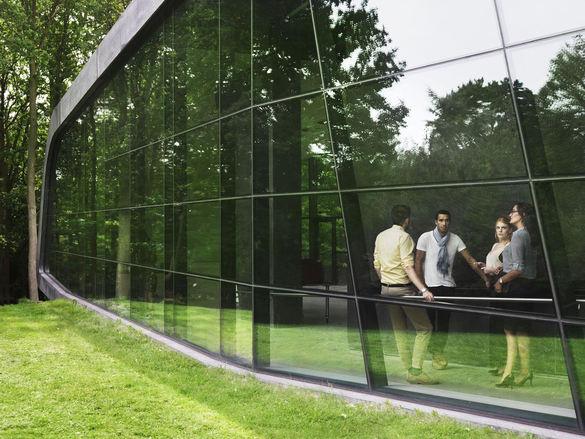 A group of people standing in front of a glass wall at a Kapsch TrafficCom event.