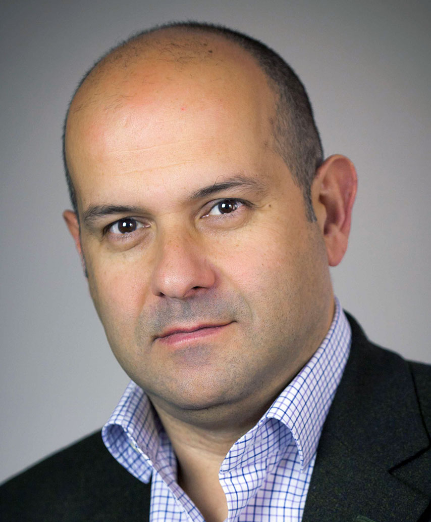 A man in a suit with a dress shirt and necktie.
