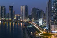 KTC7135 UAE  Sharjah Al Khan Lagoon waterfront  with the Al Qasba ferris wheel  illuminated at sunset
