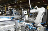 A robot at a highly automated on-board unit production line