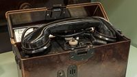 Teléfono antiguo en una caja, parte de la historia de la telefonía de Kapsch.